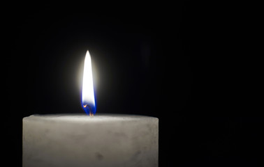 Candle flame close-up on a black background.