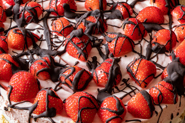 red strawberry cake with chocolate topping.