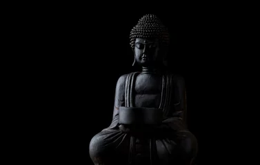 Selbstklebende Fototapeten Meditating Buddha Statue isolated on black background. Copy space. © Eugeniusz Dudziński