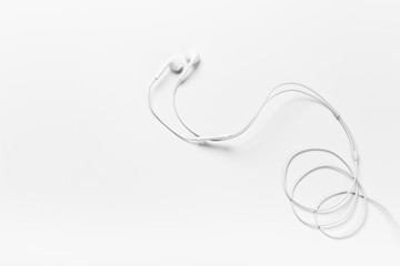 White modern headphones with a headset on a light gray background