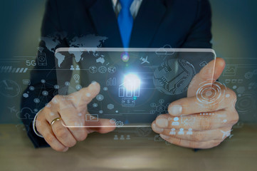 Businessman looks at a tablet and builds a strategy for the development of his business