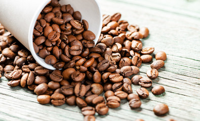 Roasted coffee beans on a wooden background, close-up, copy space.