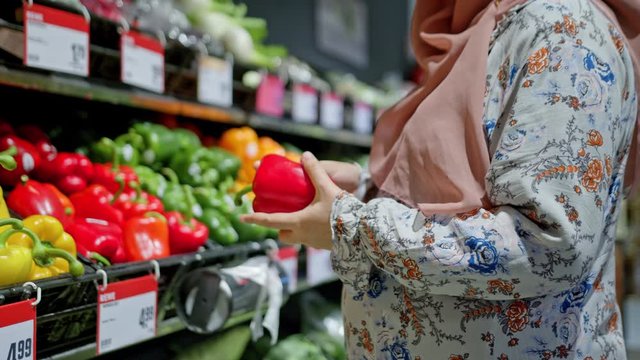 Muslim Young Pregnant Woman Close Up Belly Shopping Searching in Vegetables Section in Fancy Grocery Store Colorful Bright in Slow Motion