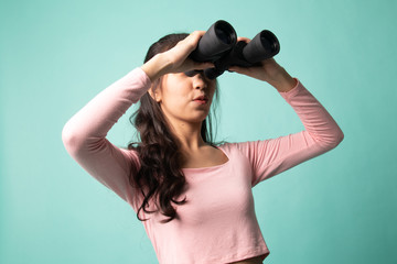 Young Asian woman with binoculars.