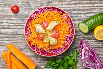 Vegan salad with red cabbage, cherry tomatoes, cucumber, carrot. Home made vegetarian food. Clean...