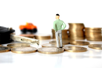 Miniature people with coins and car. Miniature businessman walking through a toy car. Concept of financial, retail, money saving and business. Turkey car price infilation. Car mortgage related
