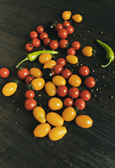Fresh ripe organic cherry tomatoes on dark background