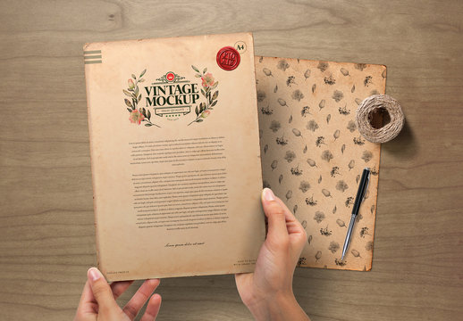 Hands Holding Vintage Paper on Wooden Background Mockup