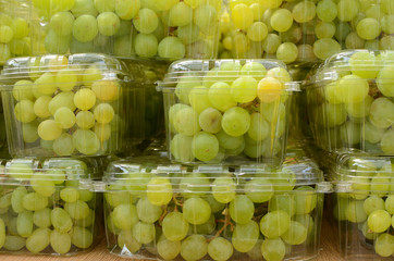 Green grape wine in the transparent plastic boxes, Czech Republic
