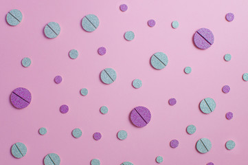 Female oral contraceptive pills on pink background. 