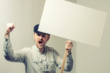 Angry protesting worker with blank protest sign