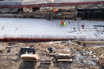 Aerial view of group of workers on construction site, working.