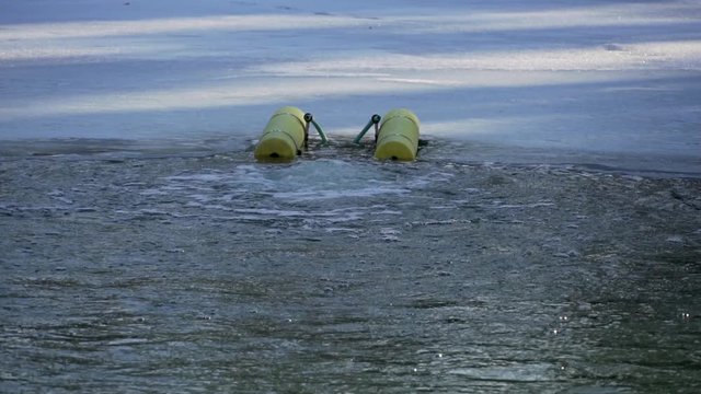 Water oxygenator working in frozen lake slow motion