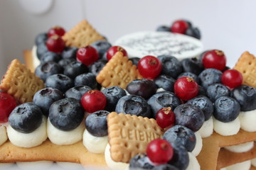Nice delicious cake with red currant, blueberries, crackers and yummy taste
