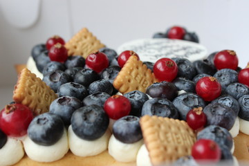 Beautiful cake with fresh berries and good wishes for happy celebration