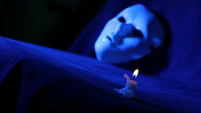 Burning candle fire and mystique mask