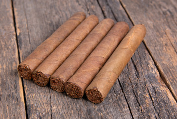 Cigars on a wooden background close up