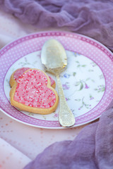 Pink heart-shaped cookies on decorated plate