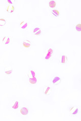 Pearl confetti on white background. Flat lay, top view.