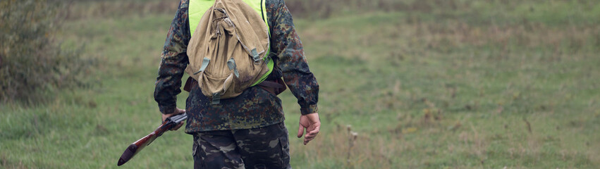 Hunters with a german drathaar and spaniel, pigeon hunting with dogs in reflective vests.