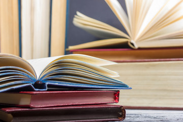 Open book, hardback books on wooden table. Back to school. Copy space