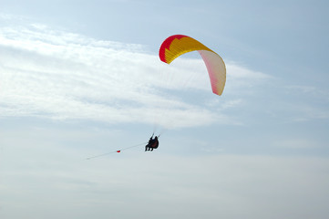 Fototapeta na wymiar Two people flying on a paraglider