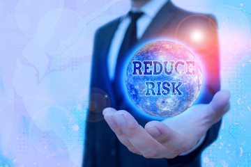 Conceptual hand writing showing Reduce Risk. Concept meaning lessen the potential damage that could...