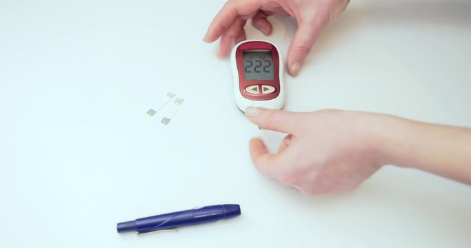 Close Up Of Female Hands Taking Blood Sample For Blood Sugar Testing. diabetes test. 