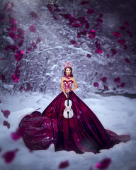 Amazing cute slim young woman in chic fairy tale image in red puffy dress and with crown on her...