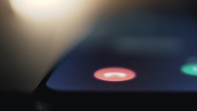 Incoming call on smartphone ringing, macro shallow depth of field pan shot