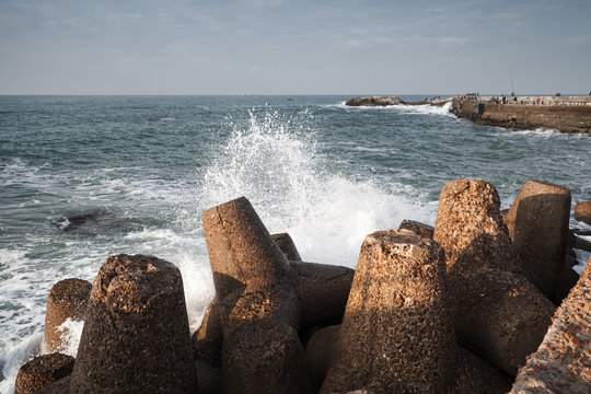 Concrete breakwater and waves. Egypt