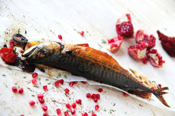  Grilled mackerel with vegetables, spices and herbs. Served on a marble table and decorated with...