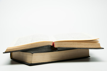 Open book. On white background. A stack of books. Old bible