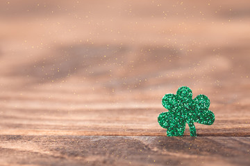St Patrick's day background with shamrock clover leaf on wood, Irish festival symbol, selective...