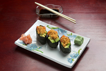 Japanese Gunkan sushi with salmon, on wooden background.