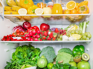 colored full fridge with fruit and vegetables