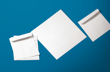 White envelope and post card on background. Top view blank envelope mockup and blank letterhead presentation template. Empty sheet for your design.