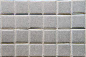 Square uneven tile in gray texture, close-up background