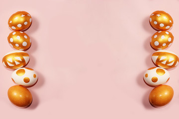 Decorated golden easter eggs on a pink background. Minimal holiday concept. Happy easter...
