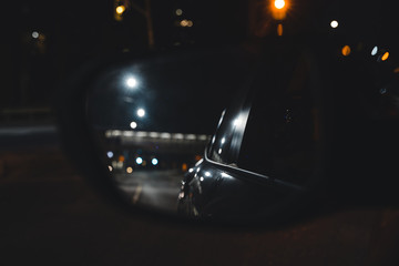 Image of Vehicle Mirror With Reflection and Traffic at night
