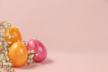 Decorated golden easter eggs on a pink background. Minimal holiday concept. Happy easter background. Creative painting of eggs at home, the idea of simple drawings for coloring, a place for text, 