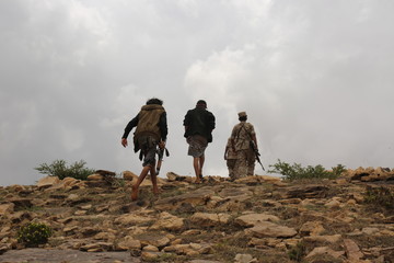 Yemeni fighters loyal to President Abd Rabbu Mansour Hadi fight against Al-Houthi rebels in Taiz,Yemen.