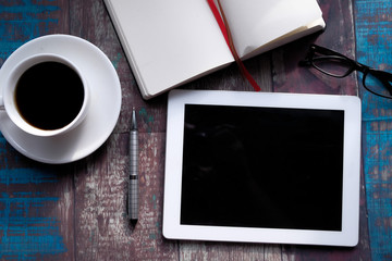 top view of digital tablet, tea and diary on table 
