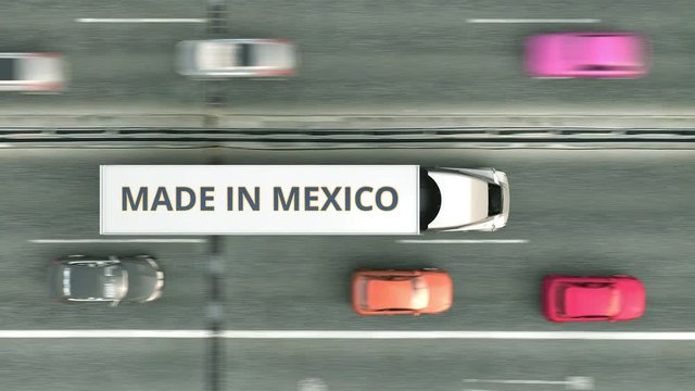 Aerial top down view of trailer trucks with MADE IN MEXICO text driving along the road. Mexican business related loopable 3D animation