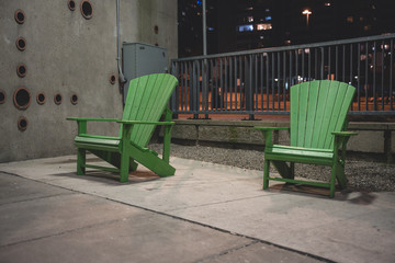 Fototapeta na wymiar Muskoka Chair in park during Night Time in the Winter Weather