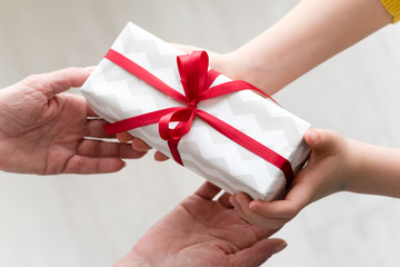 Granddaughter gives a gift to her grandmother