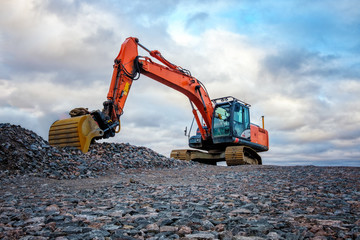 Closeup of industrial excavator working on highway construction site.
