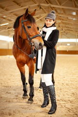 women jockey with a horse, horseback training on manege, lesson for jockey in equestrian school or club, pet animal