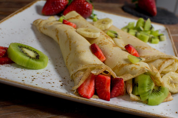 Healthy crepes with fruits, banana, kiwi and strawberry. Healthy french breakfast