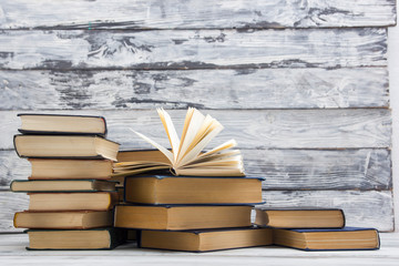 Open book, hardback books on wooden table. Back to school. Copy space